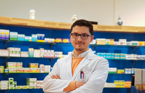 Ein junger Mann aus Syrien steht in einer Apotheke