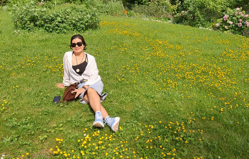 Eine Frau sitzt auf einer Wiese